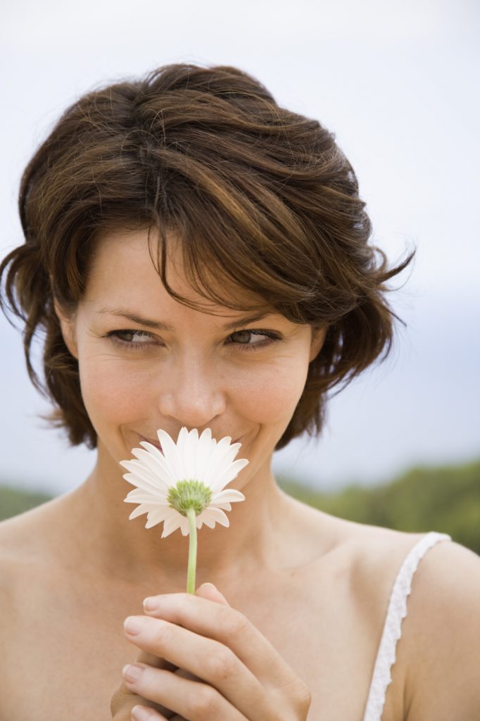 Woman smelling a flower